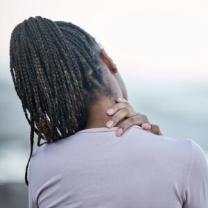 Back, black woman and neck pain with stress, injury and chronic pain. Jamaican female, lady and ath