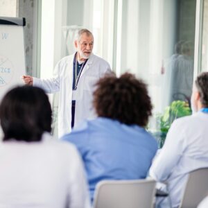 Group of doctors listening to presentation on medical conference.